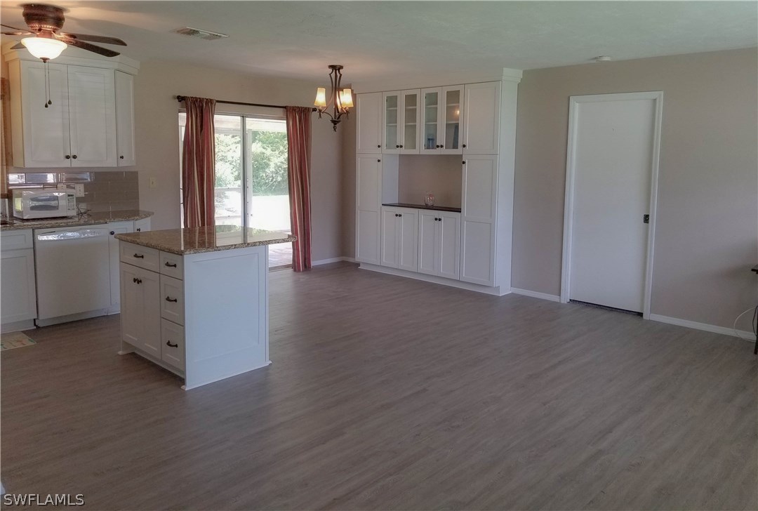 331 Delaware Road Lehigh Acres, FL 33936 - Photo 3 of 22 a view of kitchen with wooden floor
