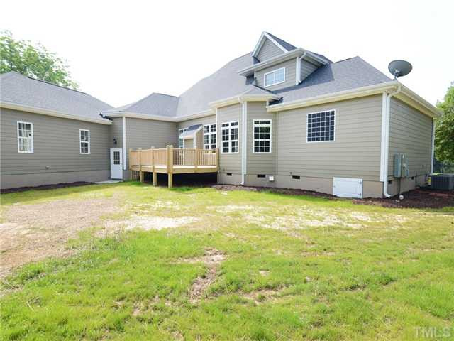 651 Friendship Church Road Middlesex, NC 27557 - Photo 25 of 25 Rear View of Home w/service door from 2 car garage side, Deck. $25k security system & sound system installed w/smart tv and will convey with acceptable offer. Exterior Back