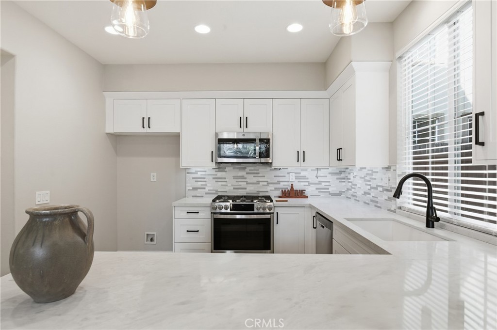 76 Kyle Court Ladera Ranch, CA 92694 - Photo 14 of 60 a kitchen with a sink stove and cabinets