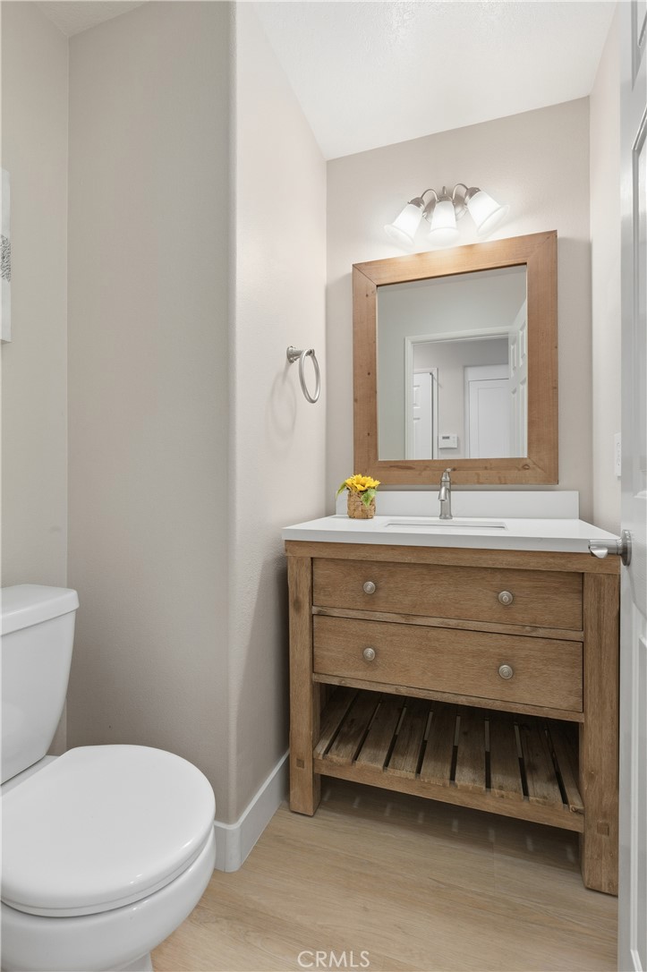 76 Kyle Court Ladera Ranch, CA 92694 - Photo 16 of 60 a bathroom with a toilet a sink and mirror
