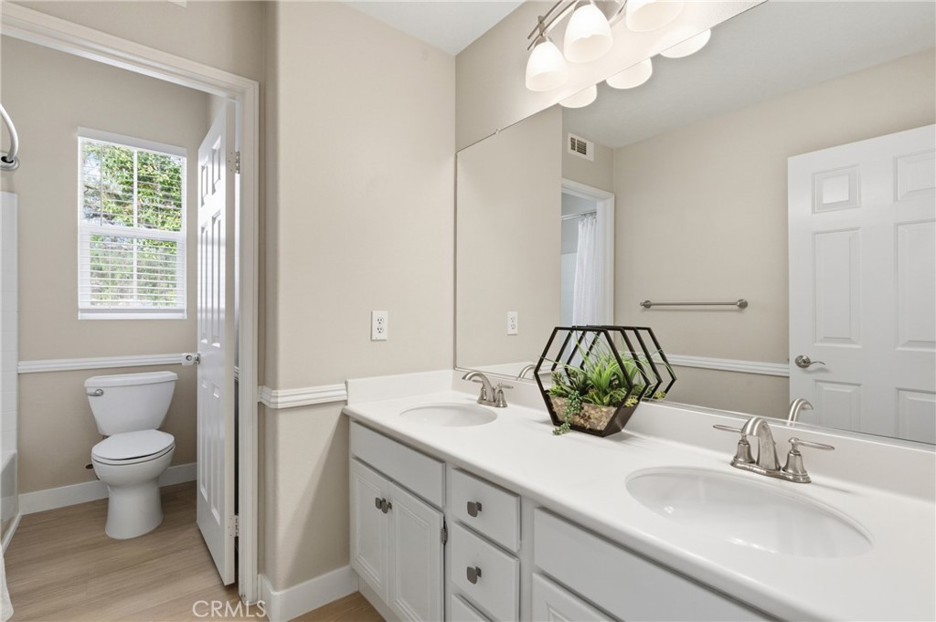 76 Kyle Court Ladera Ranch, CA 92694 - Photo 28 of 60 a bathroom with a sink a toilet and a mirror