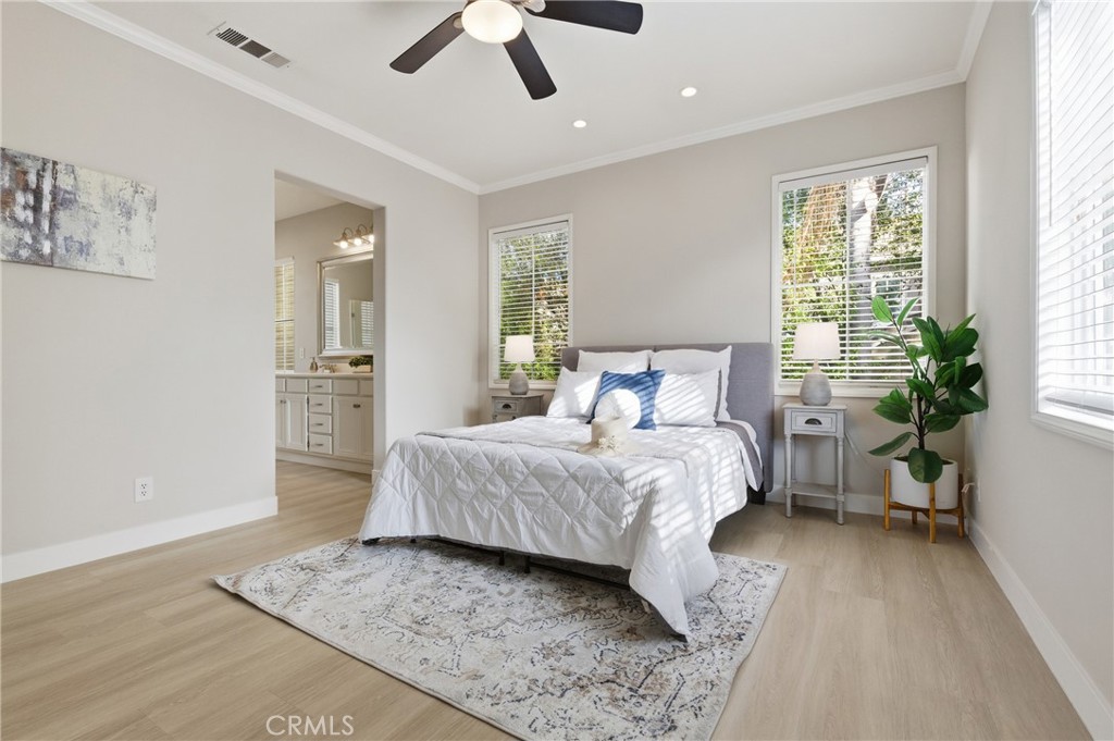 76 Kyle Court Ladera Ranch, CA 92694 - Photo 32 of 60 a bedroom with a large bed and a chandelier