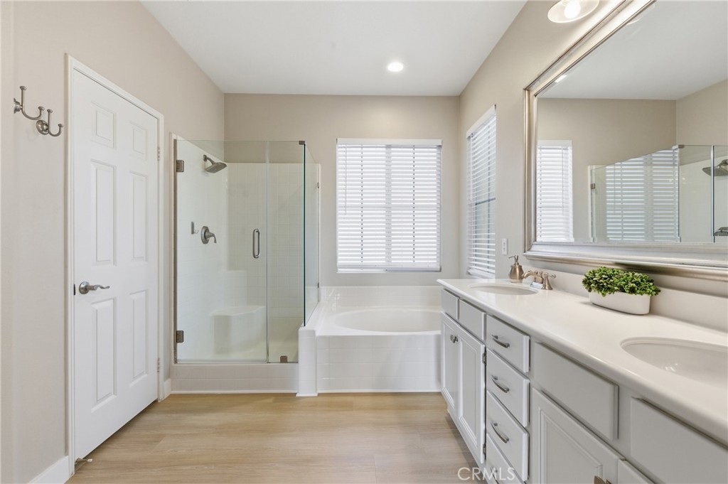 76 Kyle Court Ladera Ranch, CA 92694 - Photo 36 of 60 a spacious bathroom with a granite countertop tub sink a mirror a shower and vanity
