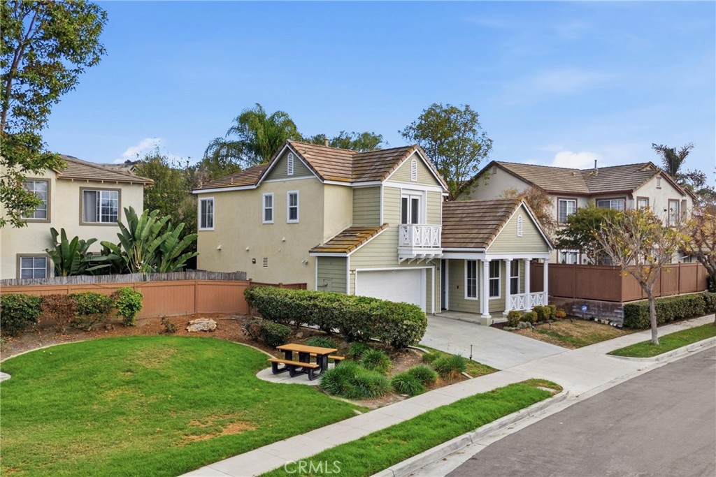 76 Kyle Court Ladera Ranch, CA 92694 - Photo 48 of 60 a front view of a house with a garden and plants