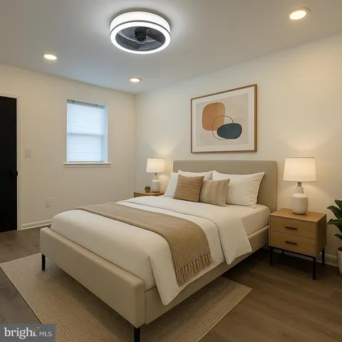 a bedroom with a bed and painting on the wall