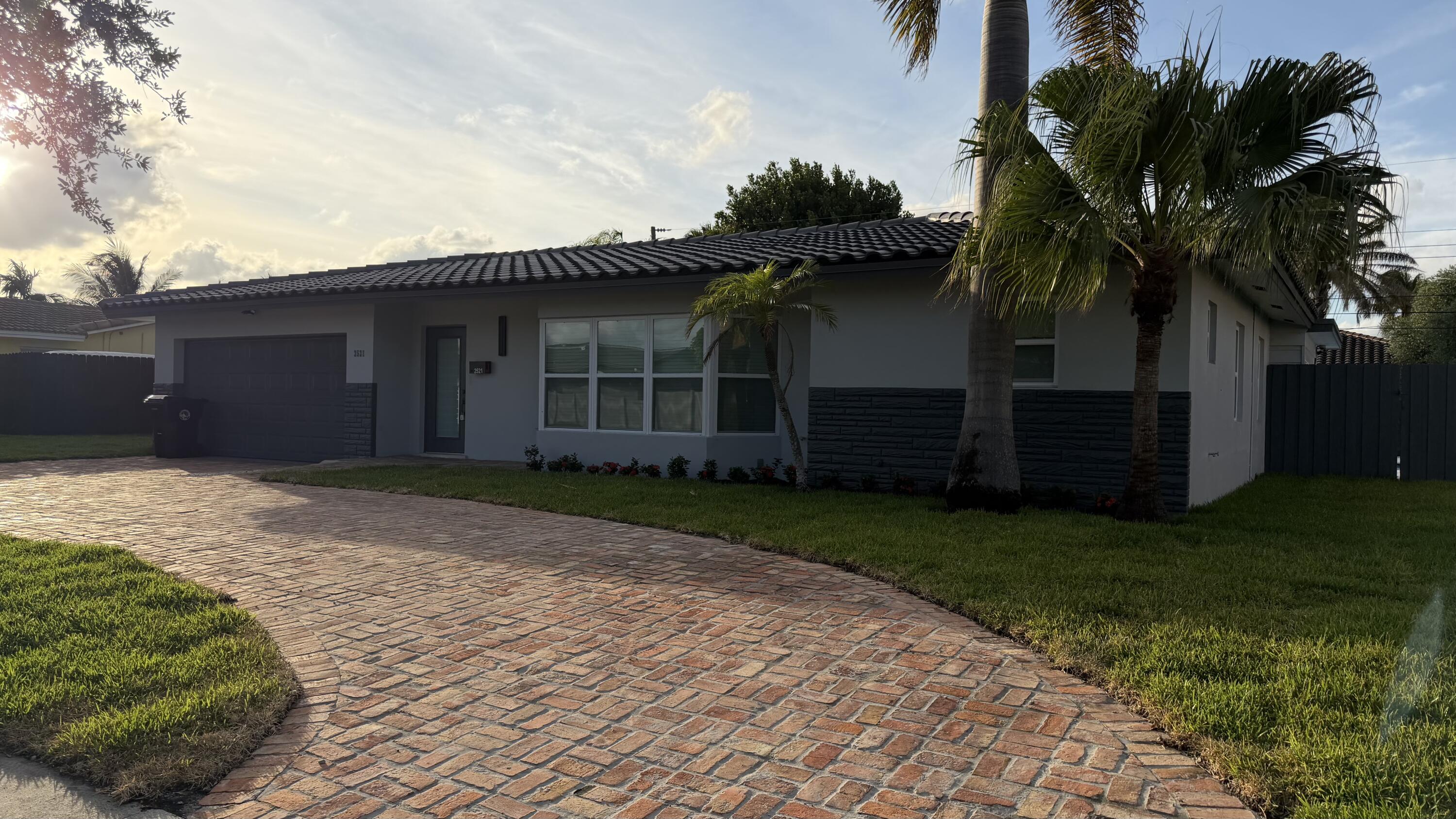 2521 Northeast 45th Street Lighthouse Point, FL 33064 - Photo 3 of 25 a house with a tree in front of it