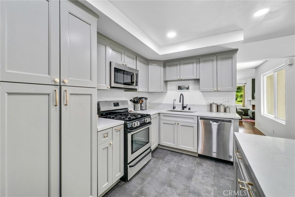 255 Scenic Way Brea, CA 92821 - Photo 13 of 57 a kitchen with white cabinets and white appliances