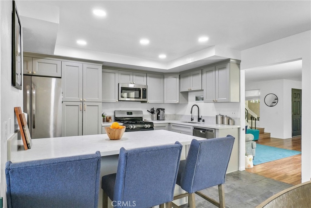 255 Scenic Way Brea, CA 92821 - Photo 14 of 57 a kitchen with a refrigerator a stove a sink a dining table and chairs