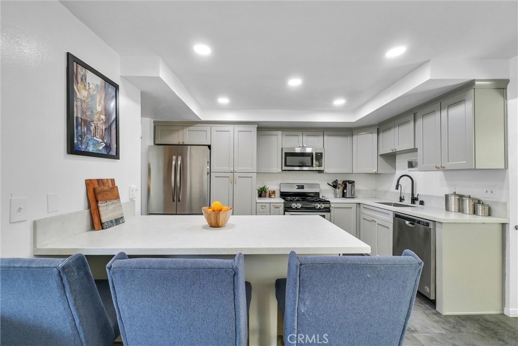 255 Scenic Way Brea, CA 92821 - Photo 16 of 57 a kitchen with a sink a stove and chairs