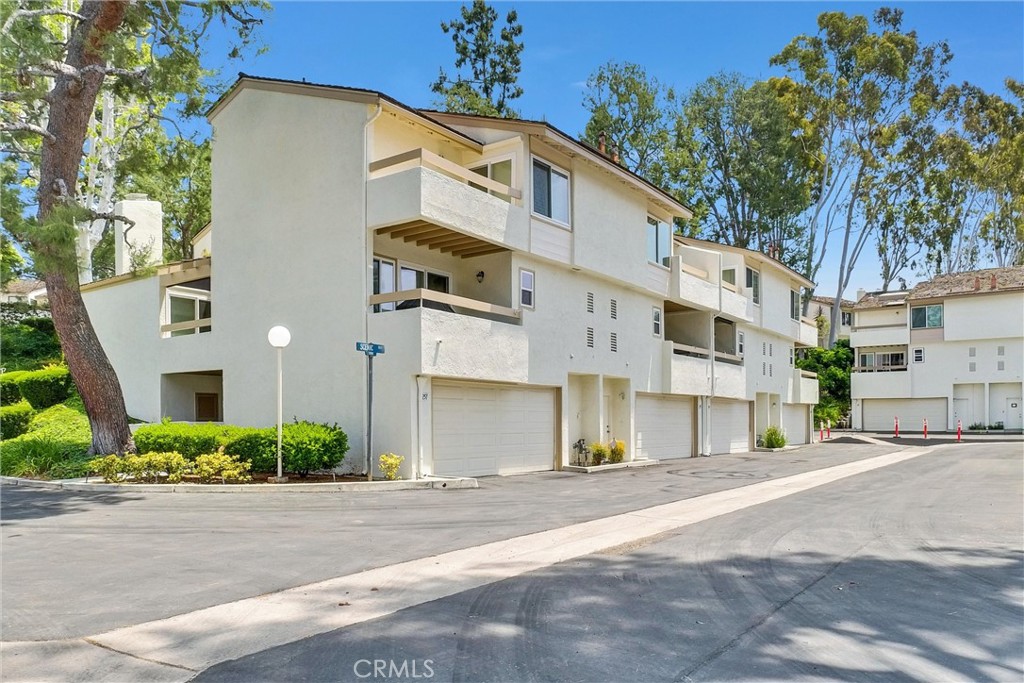 255 Scenic Way Brea, CA 92821 - Photo 46 of 57 a view of a white building among the street with palm trees