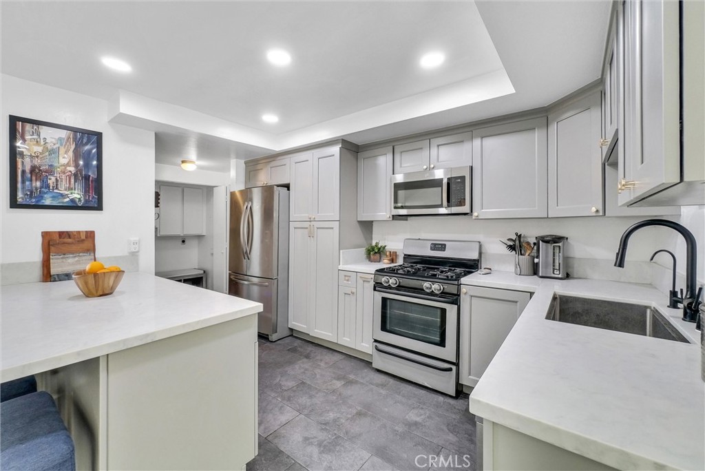 255 Scenic Way Brea, CA 92821 - Photo 10 of 57 a kitchen with stainless steel appliances a stove a sink a refrigerator a microwave a refrigerator and cabinets