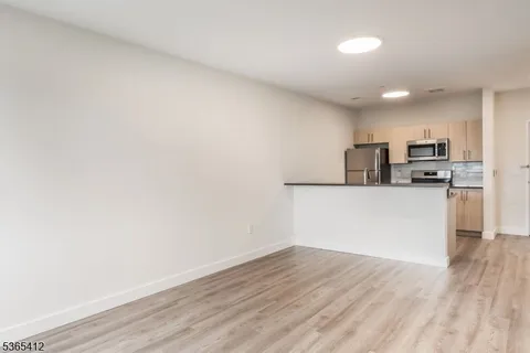 a view of a kitchen with wooden floor