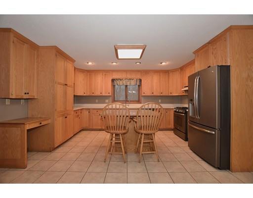 190 Old Gilbertville Road Ware, MA 01082 - Photo 5 of 30 a kitchen with stainless steel appliances kitchen island granite countertop a refrigerator a sink a stove with a dining table and chairs