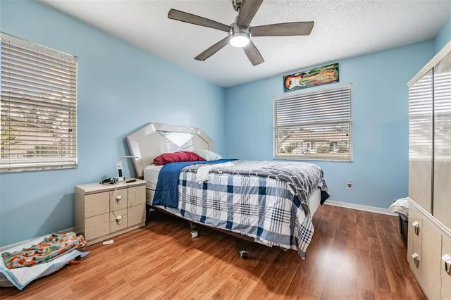a bedroom with a large bed and a chandelier