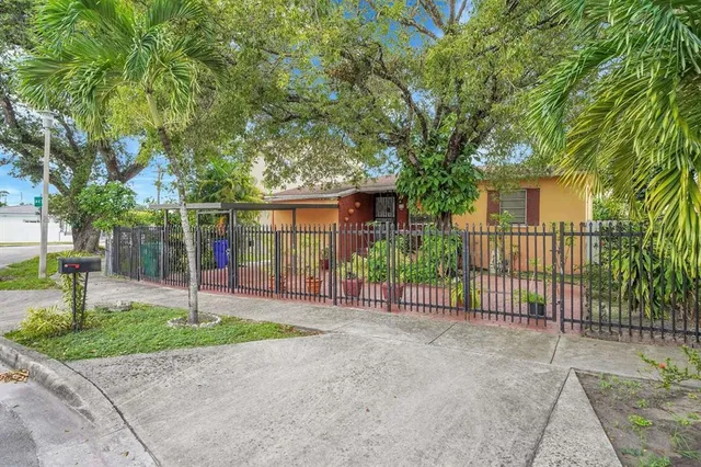 a view of a house with a small yard and plants