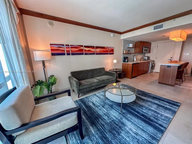 a living room with furniture and a potted plant