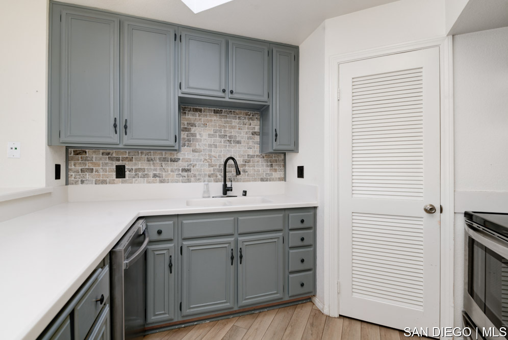 2630 Erie Street, Unit 20 San Diego, CA 92110 - Photo 1 of 9 a kitchen with white cabinets and sink