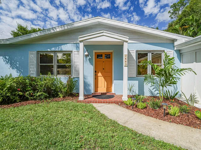 front view of a house with potted plants
