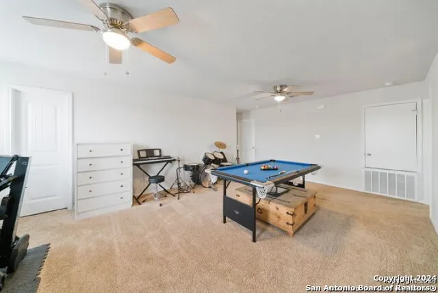 a room with furniture and a ceiling fan