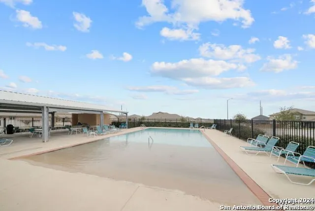 a view of a swimming pool with furniture