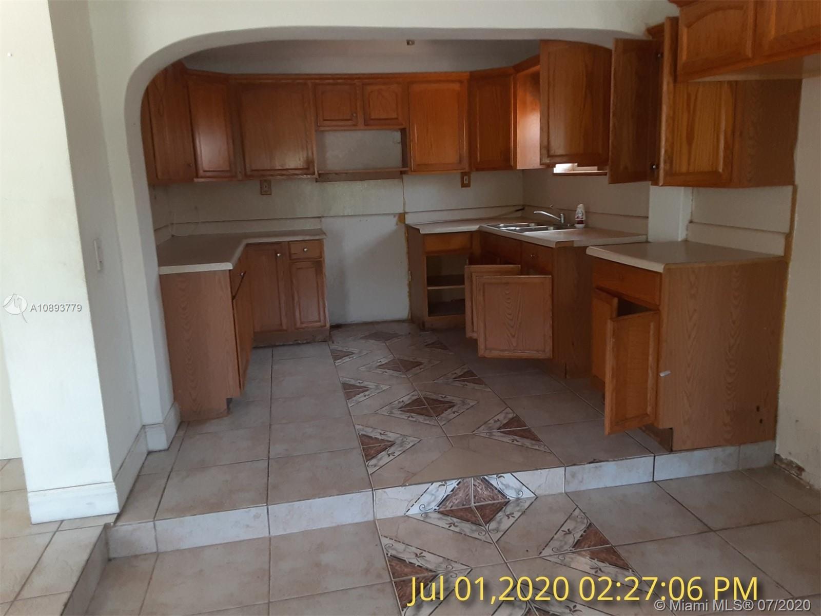 3530 Southwest 104th Avenue Miami, FL 33165 - Photo 6 of 29 a kitchen with stainless steel appliances granite countertop a sink stove and cabinets