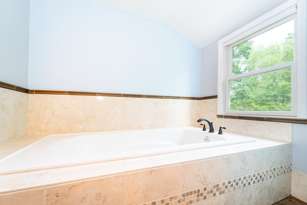 7 Braley Road Freetown, MA 02717 - Photo 29 of 42 a bathroom with a bathtub and a window