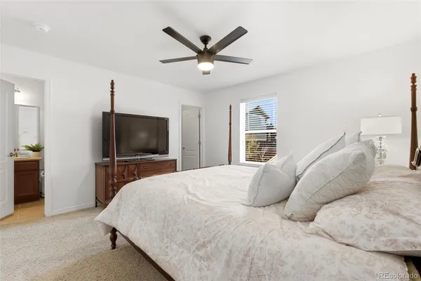 a bedroom with a large bed and a flat screen tv