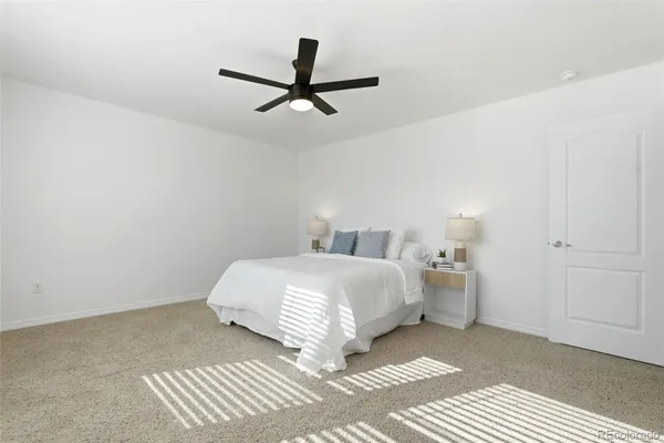 a bedroom with a bed and painting on the wall