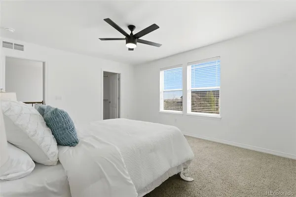 a bedroom with a large bed and a window