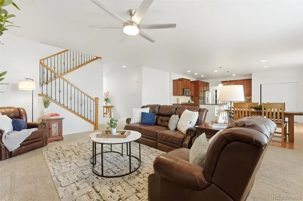 a living room with furniture and a chandelier
