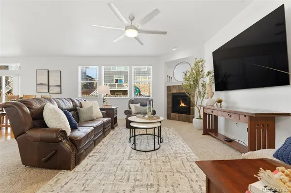 a living room with furniture a fireplace and a flat screen tv