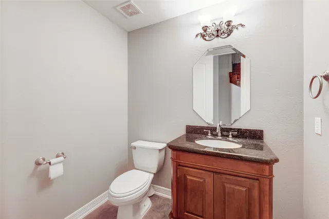 an empty room with wooden floor fireplace and windows