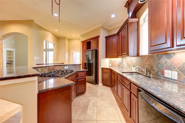 a view of an empty room with wooden floor fireplace and a window