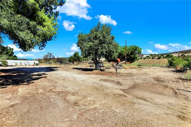 a view of a yard with mountains in the background