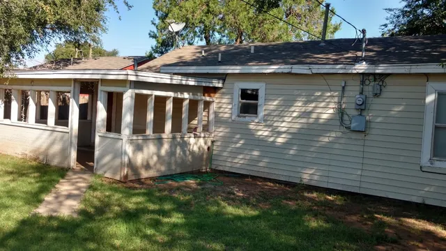 a view of a small yard with wooden fence