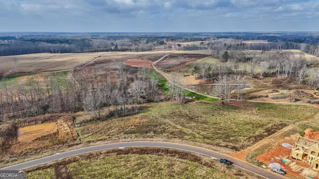 a view of a yard with a wooden fence