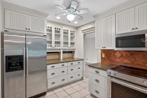 a kitchen with stainless steel appliances cabinets and a counter top space