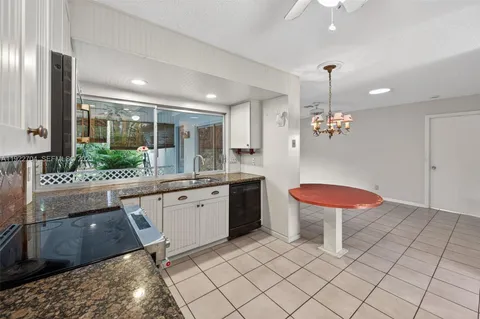 a large kitchen with a table and chairs