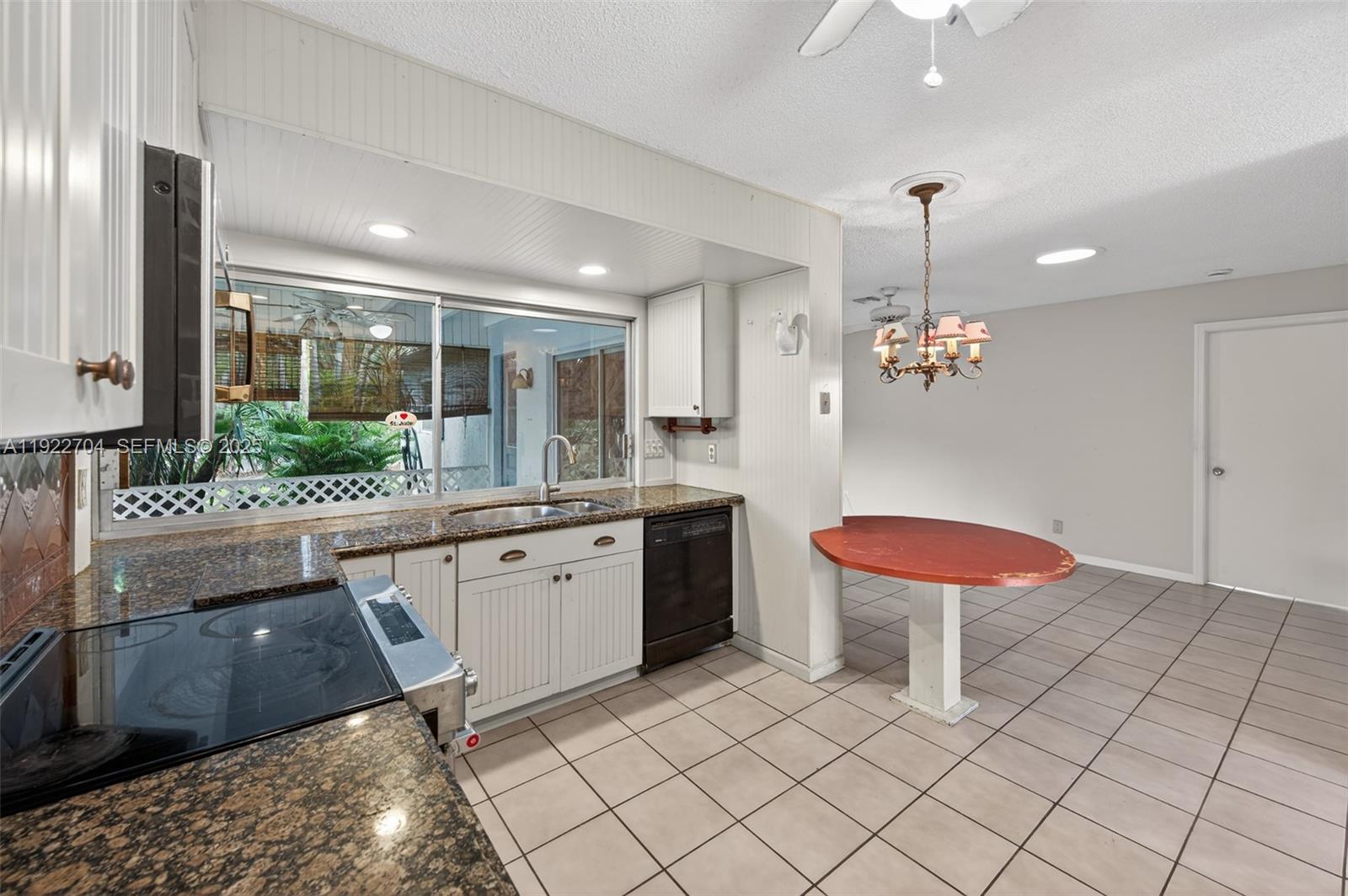 969 Northwest 8th Street Boca Raton, FL 33486 - Photo 12 of 38 a large kitchen with a table and chairs