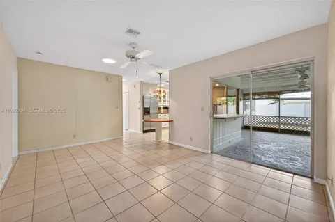 an empty room with cabinet and mirrors