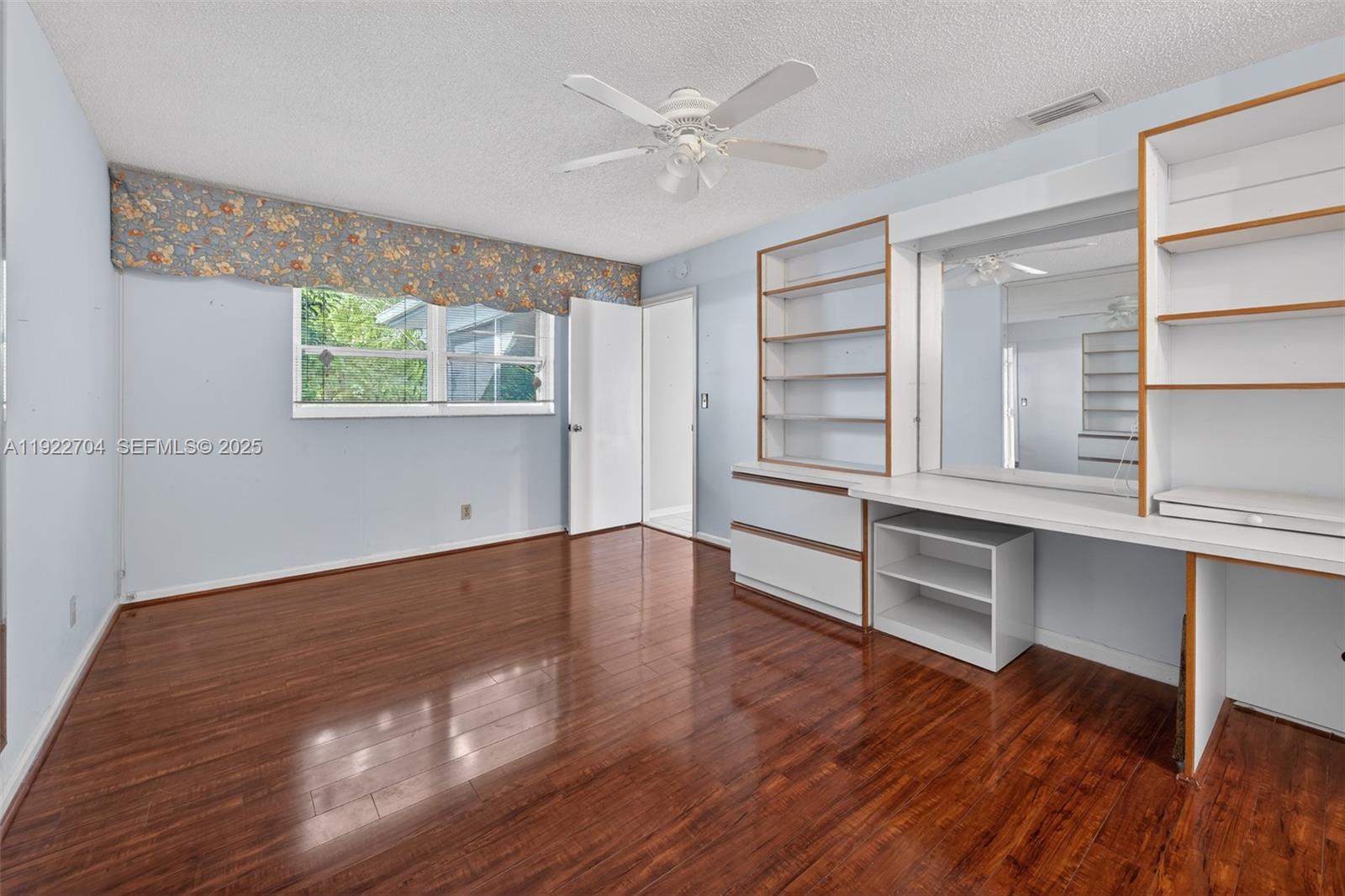969 Northwest 8th Street Boca Raton, FL 33486 - Photo 15 of 38 wooden floor in an empty room with a window