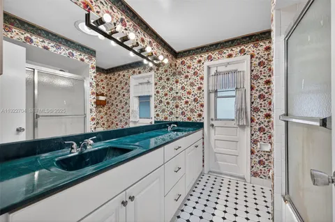 a bathroom with a double vanity sink and mirror