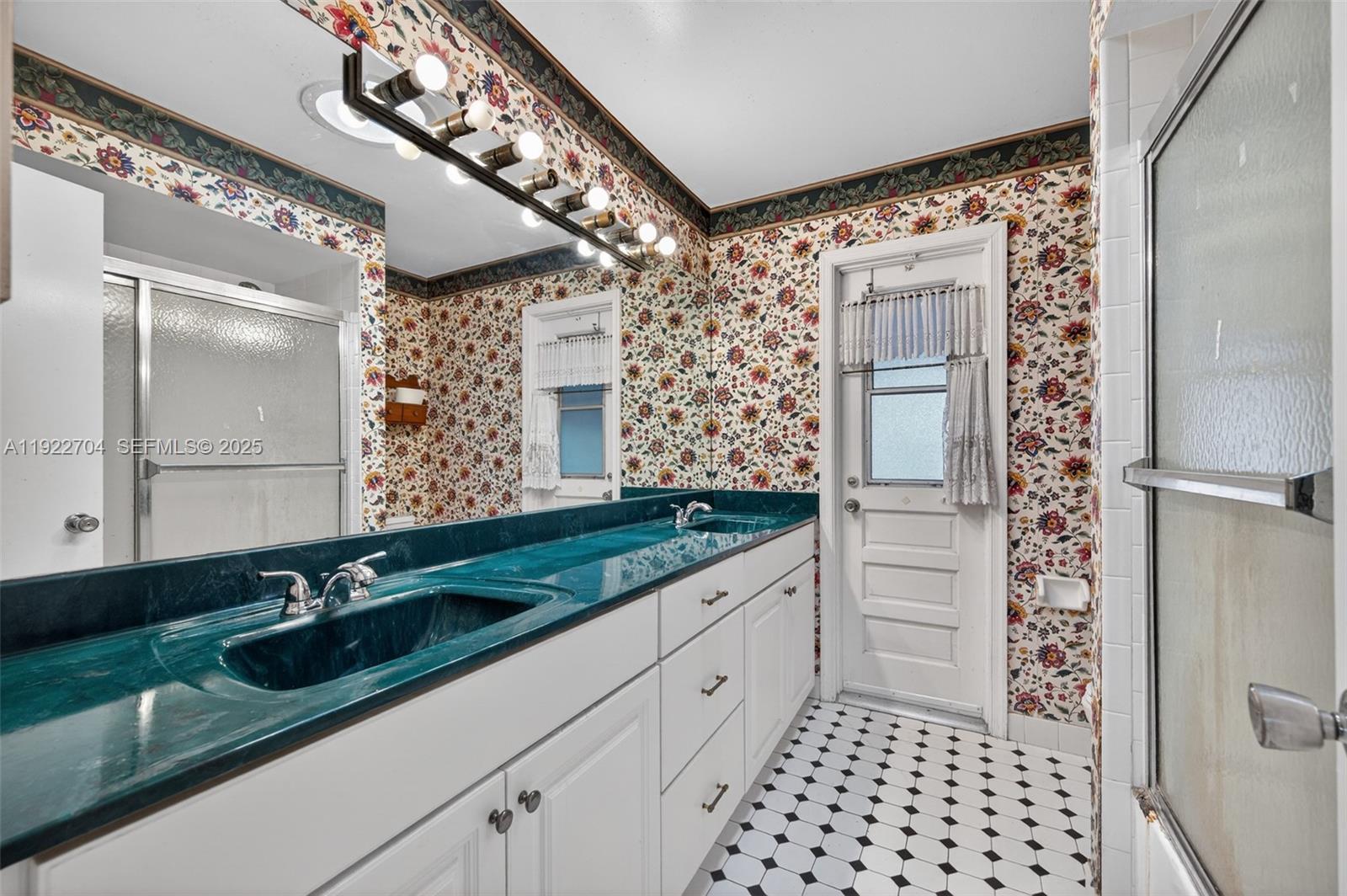 969 Northwest 8th Street Boca Raton, FL 33486 - Photo 23 of 38 a bathroom with a double vanity sink and mirror