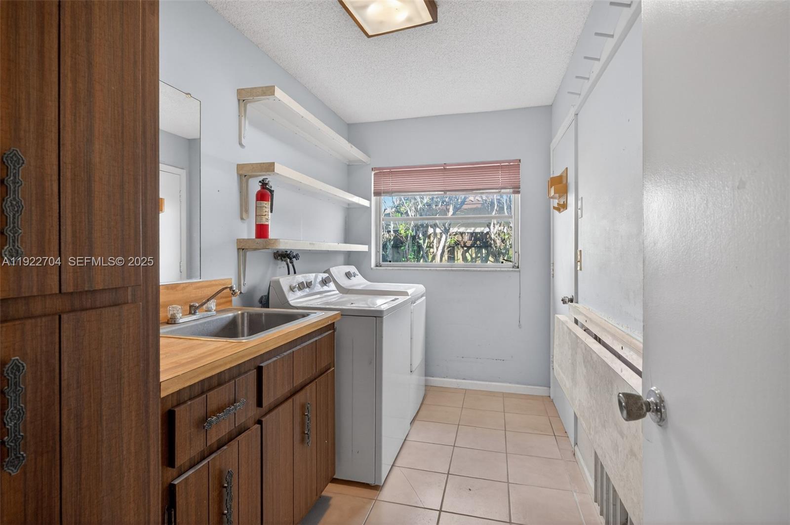 969 Northwest 8th Street Boca Raton, FL 33486 - Photo 25 of 38 a kitchen with a sink stove and cabinets