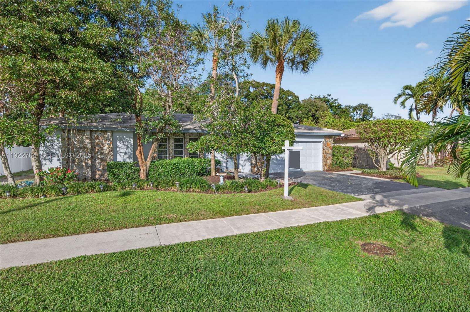 969 Northwest 8th Street Boca Raton, FL 33486 - Photo 38 of 38 a view of a house with a big yard and palm trees