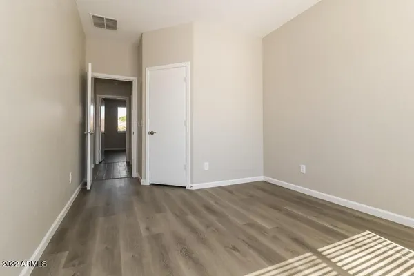 a bathroom with a sink a toilet a window and vanity