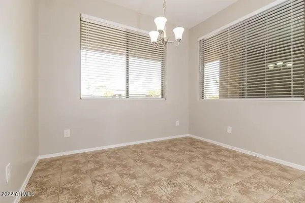 a kitchen with stainless steel appliances a sink a stove a refrigerator a sink and white cabinets