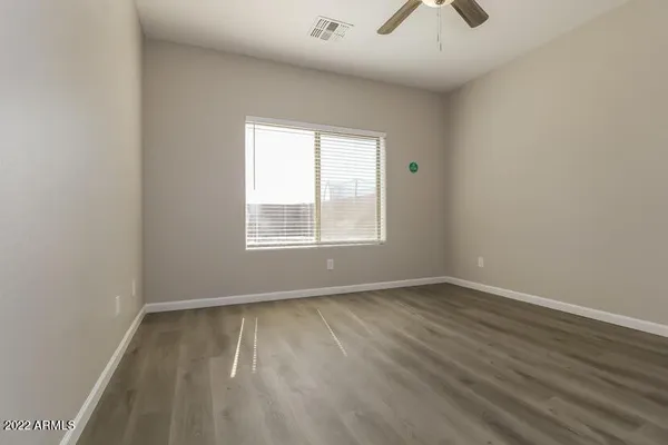 an empty room with wooden floor and closet