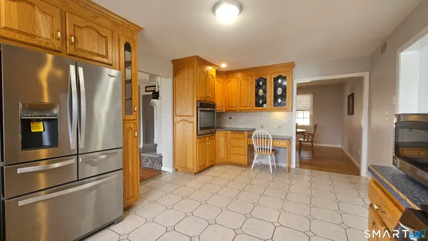 a kitchen with stainless steel appliances granite countertop a refrigerator and a stove top oven