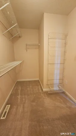 a bedroom with a bed window and dresser